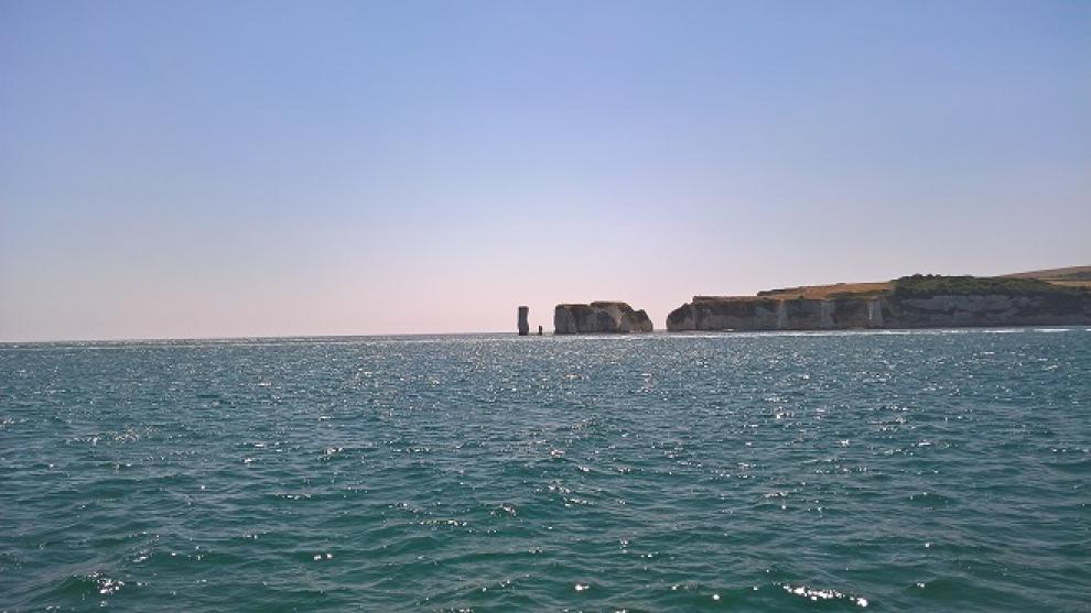 Seascape with cliffs in the distance