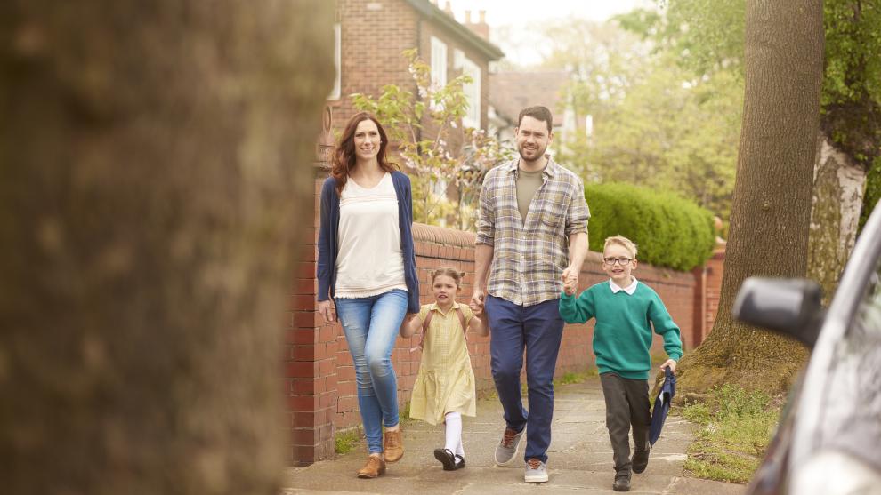 Family walking to school with adopted children
