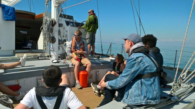 Group of students on a boat in the middle of the sea during Tall Ships residential trip 2018.